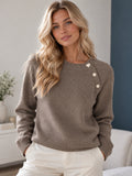 Half-length view of the knit sweater with pearl shoulder buttons
